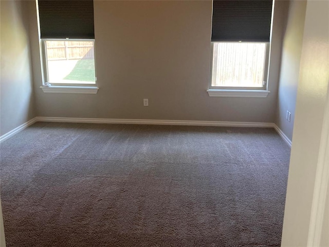 carpeted empty room featuring plenty of natural light