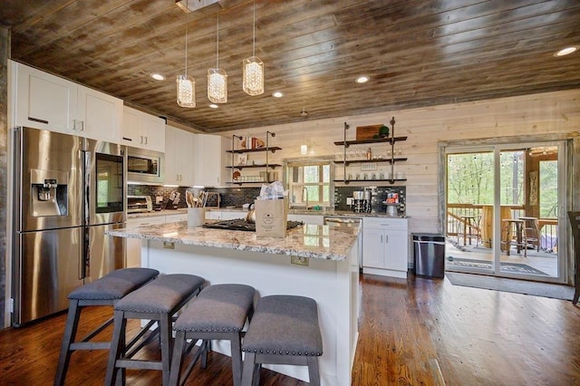 kitchen featuring white cabinets, wooden walls, dark hardwood / wood-style floors, wood ceiling, and stainless steel appliances