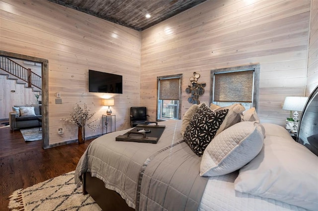 bedroom with wooden walls, wooden ceiling, and dark wood-type flooring