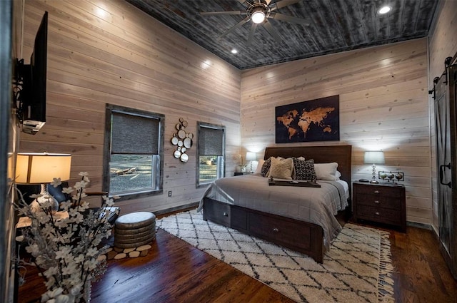 bedroom with hardwood / wood-style floors, ceiling fan, wooden walls, and vaulted ceiling