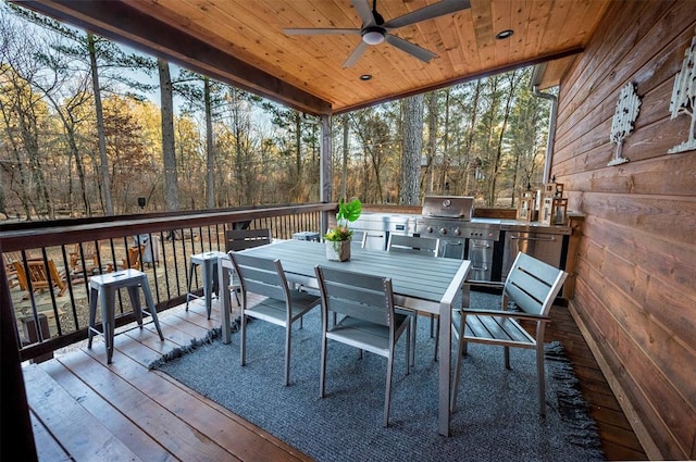 wooden deck featuring grilling area and ceiling fan