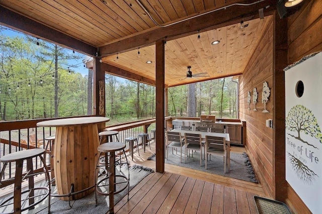 sunroom featuring ceiling fan, plenty of natural light, and wooden ceiling