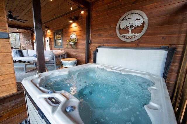 exterior space featuring a porch, a hot tub, and ceiling fan