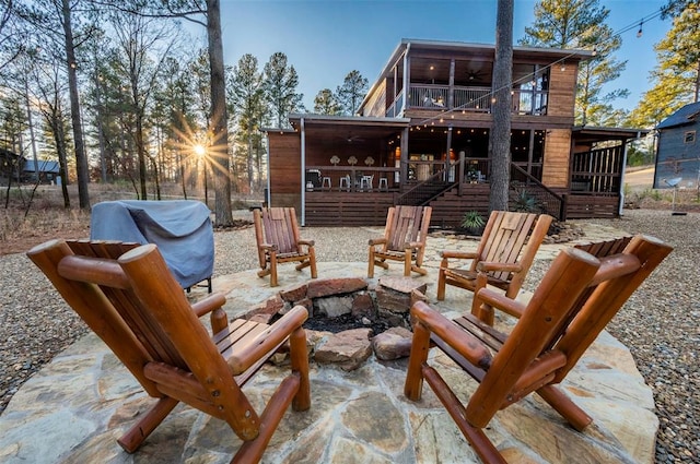 view of patio / terrace with a balcony, a fire pit, and ceiling fan