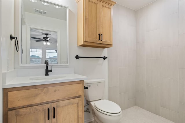 bathroom featuring ceiling fan, vanity, and toilet