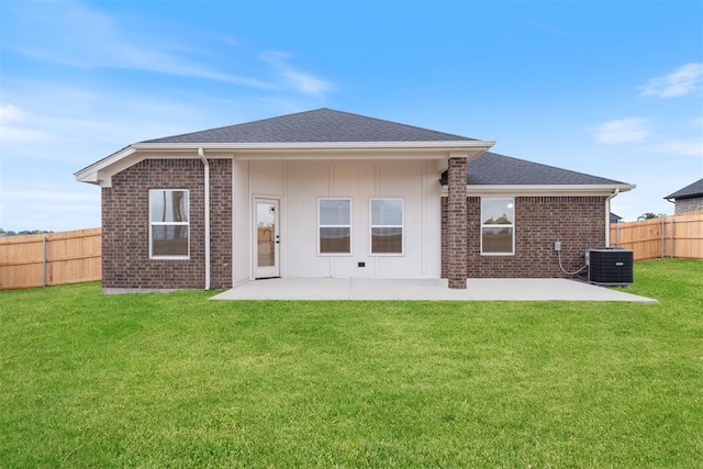 back of house featuring a patio area, a yard, and central AC unit