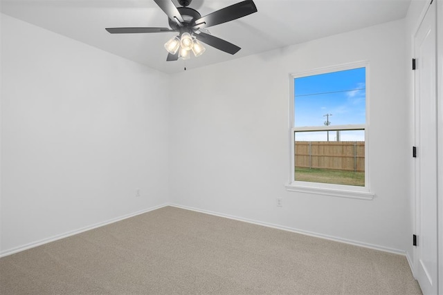 spare room featuring carpet and ceiling fan