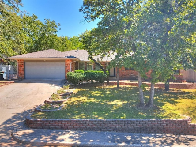 view of front of property featuring a front yard and a garage