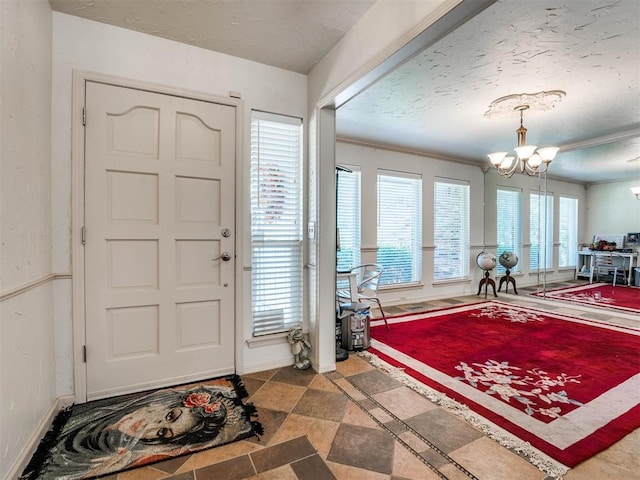 entrance foyer featuring a notable chandelier and crown molding