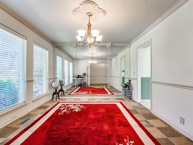 interior space featuring ornamental molding and an inviting chandelier