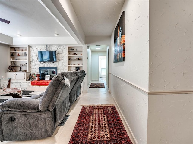 hall featuring built in shelves and light tile patterned floors