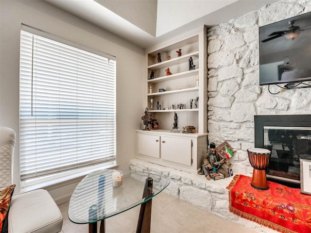 living room with built in features and a fireplace