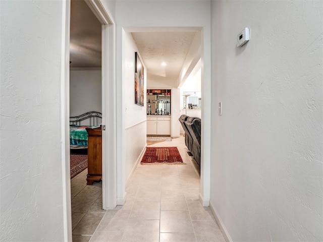 corridor with light tile patterned floors