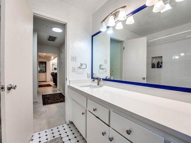 bathroom featuring tile patterned flooring and vanity