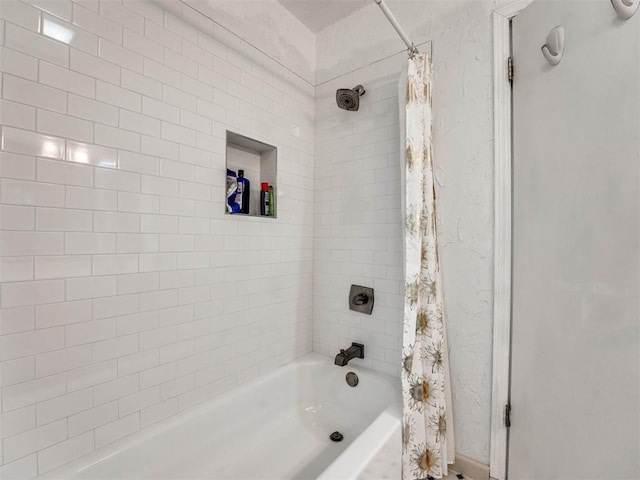 bathroom with shower / bathtub combination with curtain