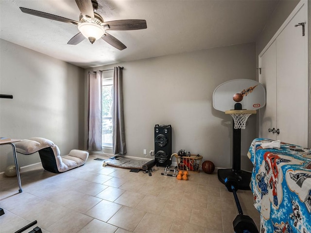 tiled bedroom with ceiling fan and a closet