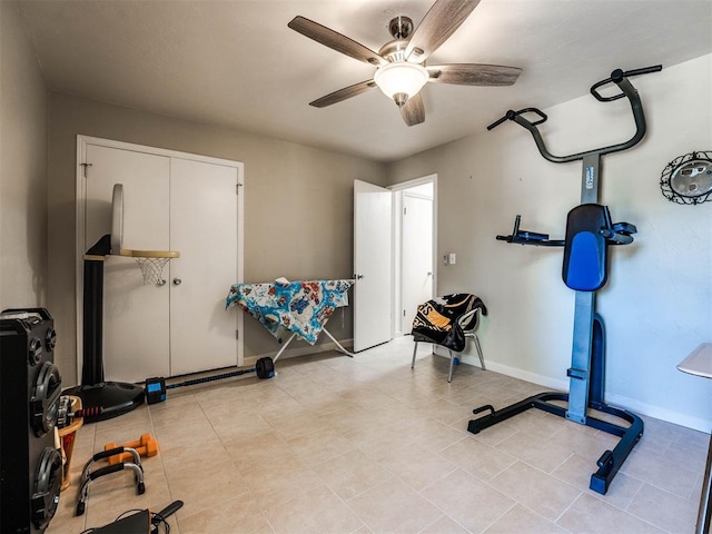 workout room with ceiling fan and light tile patterned floors