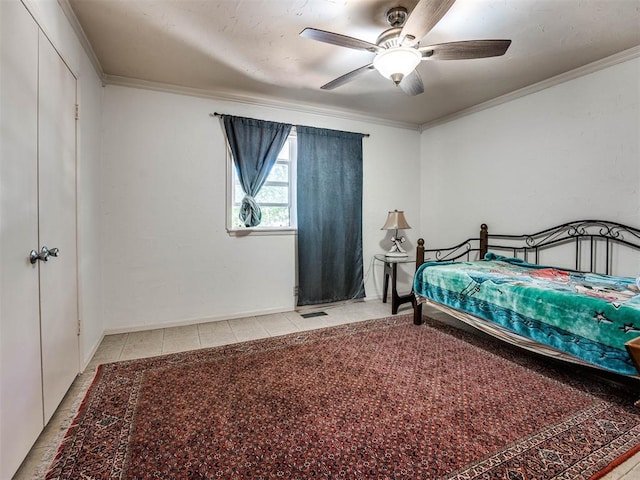 bedroom featuring ceiling fan, crown molding, and light tile patterned flooring