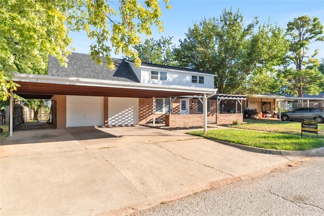 view of front of home featuring a carport, a garage, and a front yard