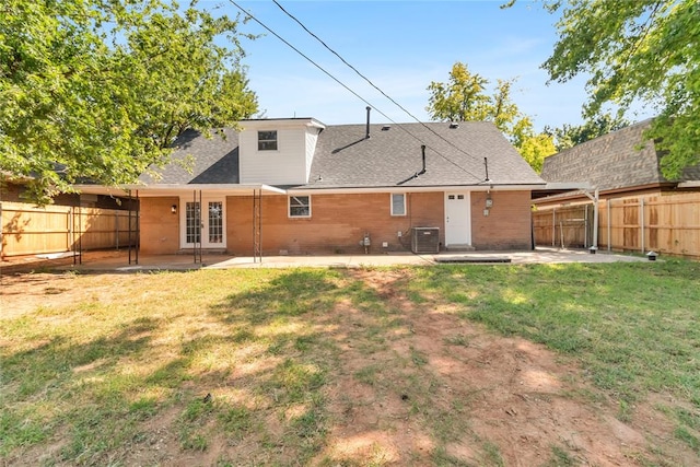 back of house with french doors, central AC unit, a patio, and a lawn