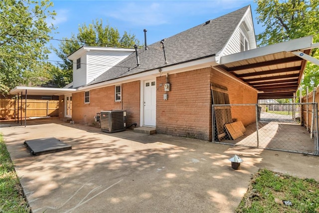 rear view of property featuring central AC