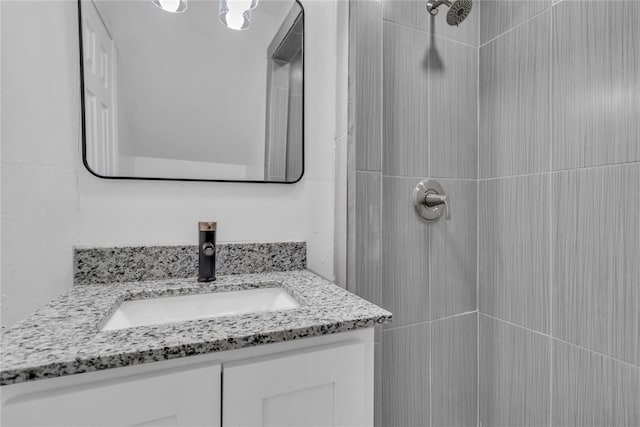 bathroom featuring vanity and a tile shower