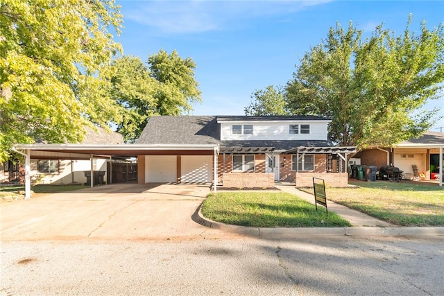 view of front facade with a front lawn and a carport