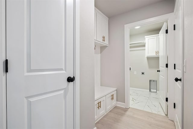 mudroom with light hardwood / wood-style flooring