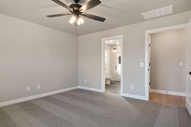 unfurnished bedroom featuring carpet, ceiling fan, and ensuite bath