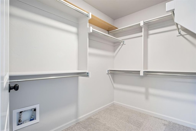 walk in closet with carpet