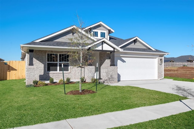 view of front of home featuring a front yard and a garage