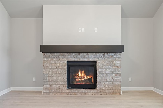 interior details featuring a fireplace and hardwood / wood-style floors