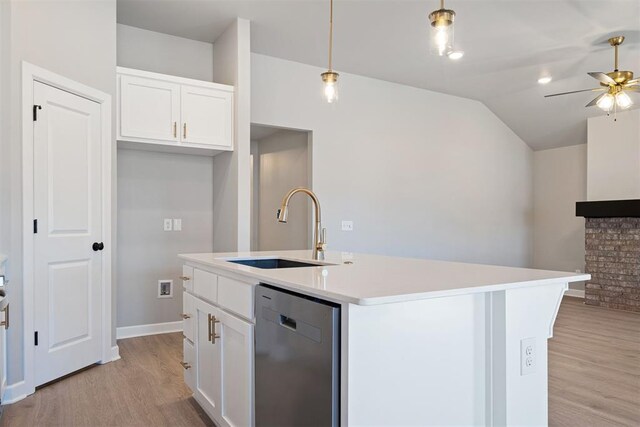 kitchen with white cabinetry, dishwasher, sink, hanging light fixtures, and an island with sink