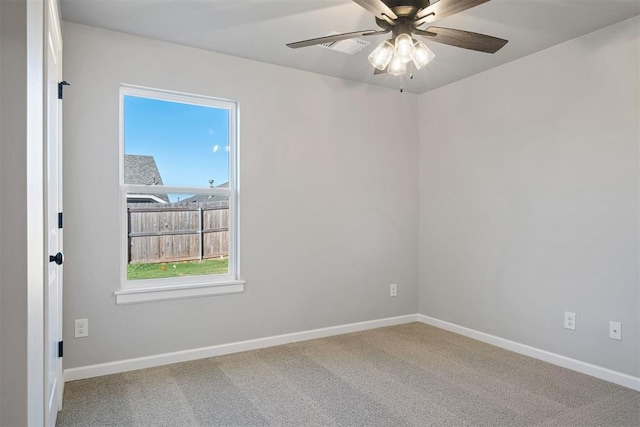 carpeted spare room featuring ceiling fan