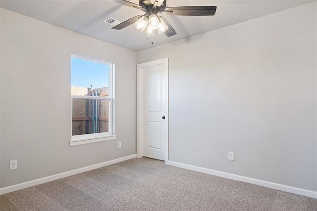 carpeted empty room featuring ceiling fan