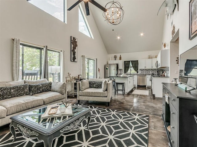 living room with ceiling fan with notable chandelier and high vaulted ceiling