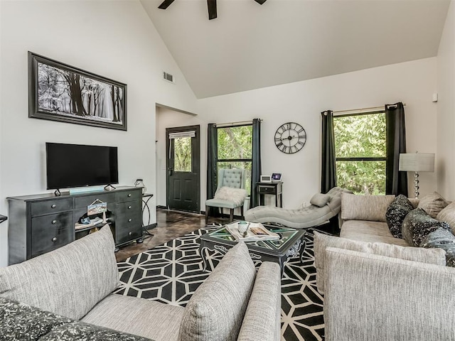 living room with ceiling fan, a healthy amount of sunlight, dark hardwood / wood-style floors, and high vaulted ceiling