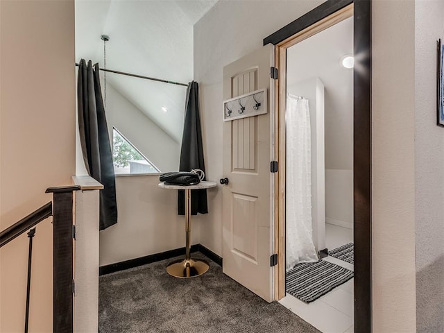 hallway with carpet and lofted ceiling