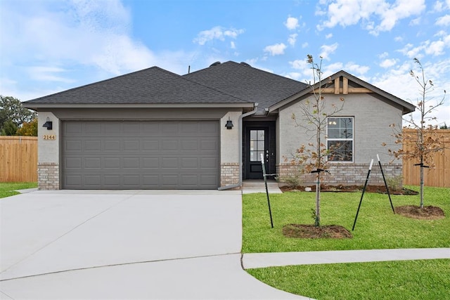 view of front facade with a front yard and a garage