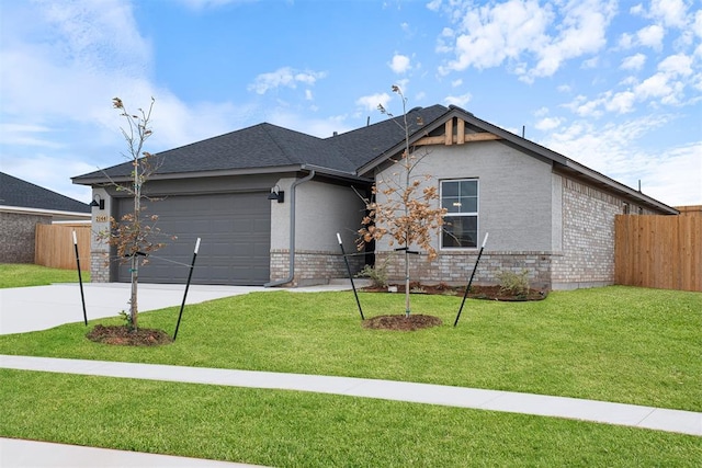 view of front of home featuring a garage and a front lawn