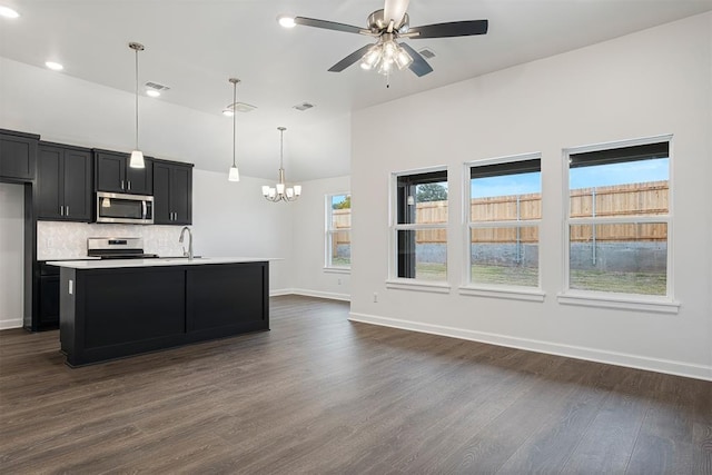 2144 Emily Rae Ln, Blanchard, OK 73010 - kitchen featuring stainless steel appliances, dark cabinetry, a chandelier, dark wood finished floors, and a ceiling fan
