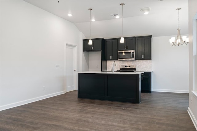 2144 Emily Rae Ln, Blanchard, OK 73010 - kitchen featuring stainless steel appliances, vaulted ceiling, decorative backsplash, light countertops, and a chandelier