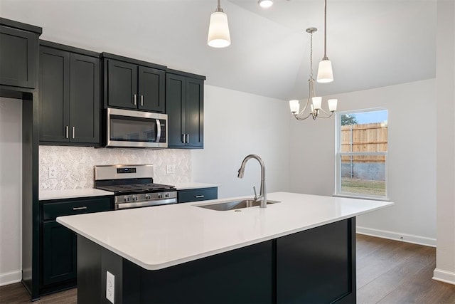 2144 Emily Rae Ln, Blanchard, OK 73010 - kitchen featuring stainless steel appliances, backsplash, light countertops, an island with sink, and lofted ceiling