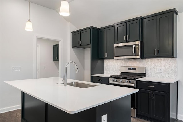 2144 Emily Rae Ln, Blanchard, OK 73010 - kitchen with stainless steel appliances, backsplash, a center island with sink, light countertops, and hanging light fixtures