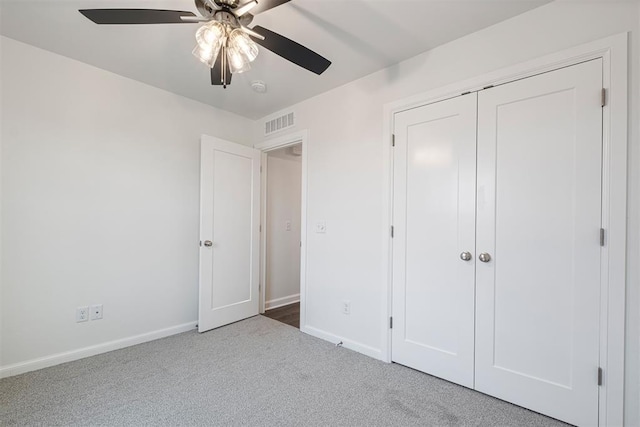 2144 Emily Rae Ln, Blanchard, OK 73010 - unfurnished bedroom featuring carpet, a closet, and a ceiling fan