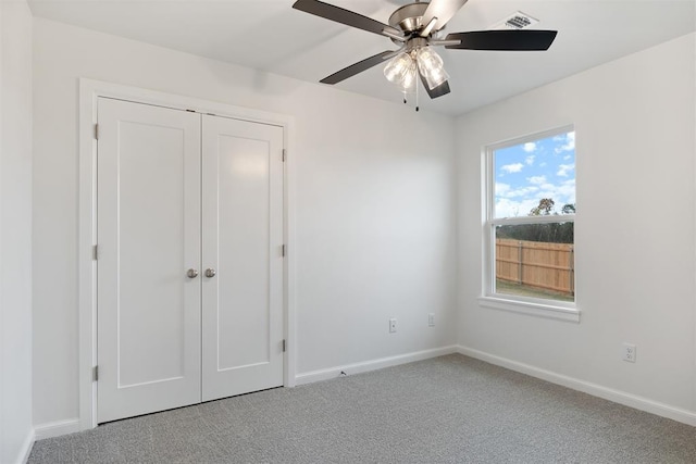 2144 Emily Rae Ln, Blanchard, OK 73010 - unfurnished bedroom featuring light colored carpet, a ceiling fan, and a closet