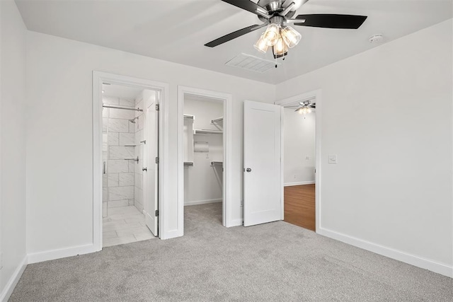 2144 Emily Rae Ln, Blanchard, OK 73010 - unfurnished bedroom with carpet, a walk in closet, a closet, ensuite bath, and a ceiling fan