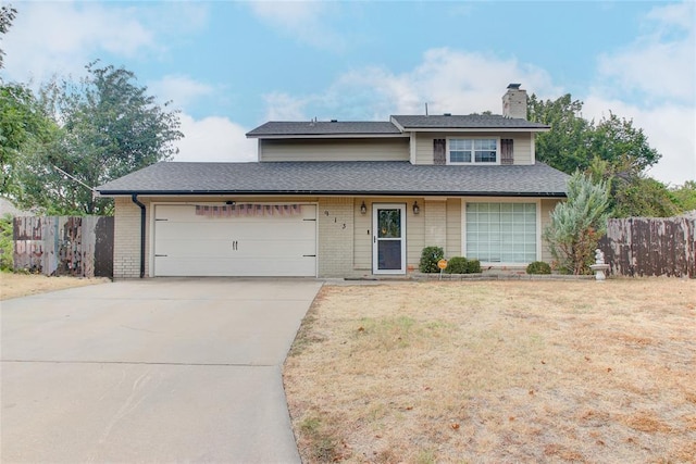 view of property with a garage and a front lawn