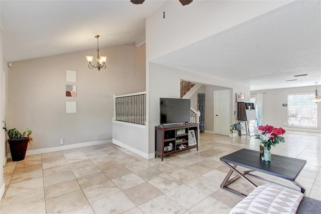 tiled living room featuring ceiling fan with notable chandelier and lofted ceiling