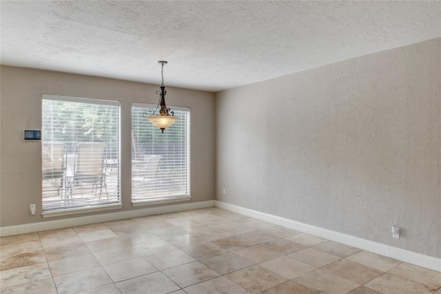 spare room featuring a textured ceiling